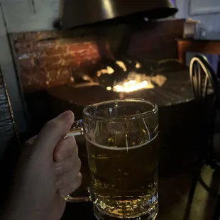 a person holding a glass of beer