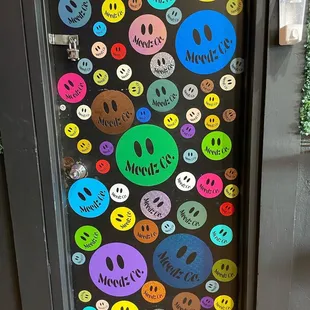 a bunch of smiley faces on a door