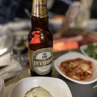 a plate of food and a bottle of beer