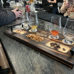 a tray of beer and snacks