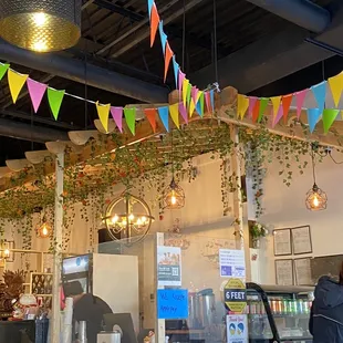 The ceiling with leaves hanging and a colorful banner