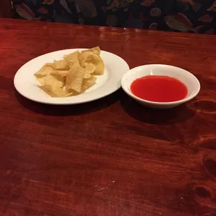 Chips and mystery red sweet sauce served immediately.