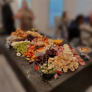 A charcuterie table large enough to feed at least 50 people for a catered event