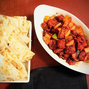 a plate of naan bread and a bowl of stew