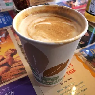 Regular small latte at the "love booth" decorated with romantic novel covers