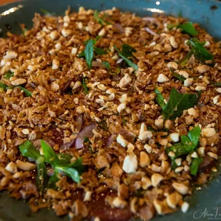 Carpaccio - thinly sliced tenderloin, topped with a spicy citrus cham cheo sauce and spring greens