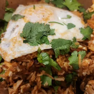 a fried egg on top of rice