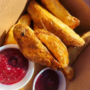 a box of french fries and a bowl of ketchup