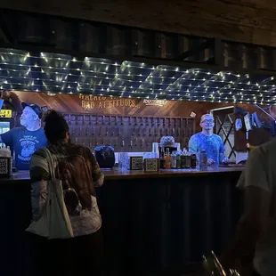 a man and a woman standing in front of a bar