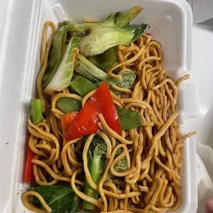 noodles and vegetables in a styrofoam container