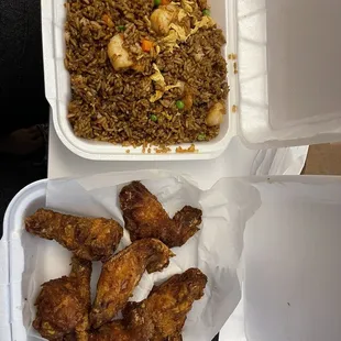 chicken wings and rice in a styrofoam container