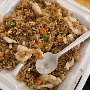 rice with chicken and vegetables in a styrofoam container