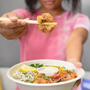a woman holding a bowl of food