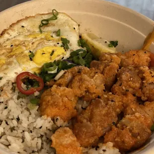 Korean hot chicken bowl with sesame seed rice and a fried egg