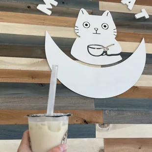 a hand holding a drink