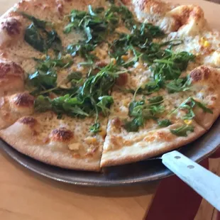 White pie with corn and arugula