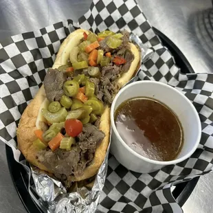 a hot dog and a bowl of sauce