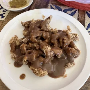 Steak fingers with brown gravy.