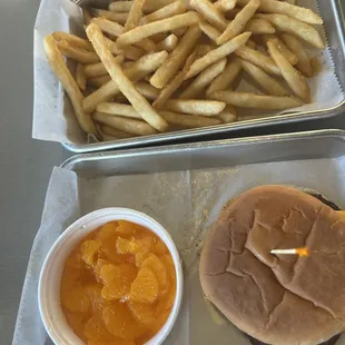 kids cheeseburger with pickles, cheese, and oranges