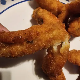a plate of fried fish sticks with dipping sauce