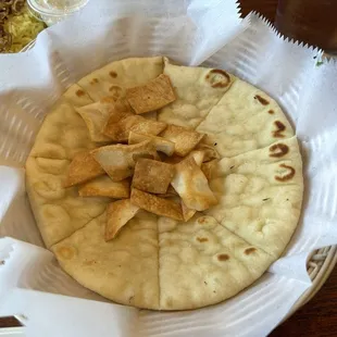 Pita served two ways, a fun touch and fun to eat. Little pita chips and fresh.