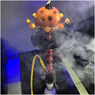 a pumpkin smoking a hookah