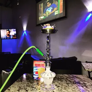 a hookah with a green hose