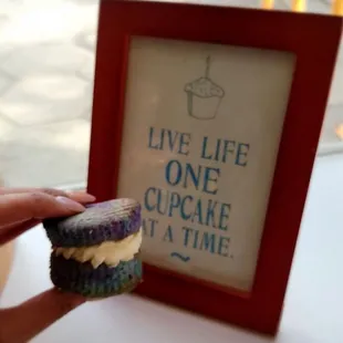 a person holding a cupcake