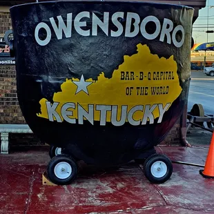 ows a large black barrel with a kentucky sign on it