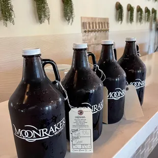 a row of jugs on a counter