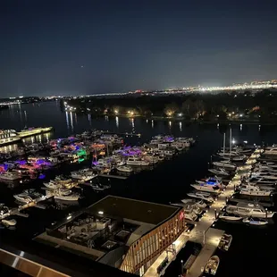 boats docked at a marina at night