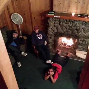 Family enjoying the nice cozy fireplace