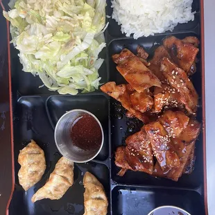 Dinner bento box with spicy chicken