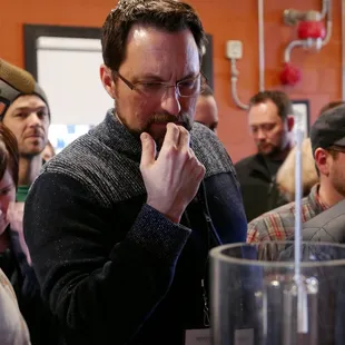 Student tastes distillate coming off the still.