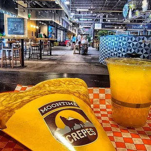 Breakfast crepe and fresh-squeezed orange juice in Edgewater Public Market food courtyard.