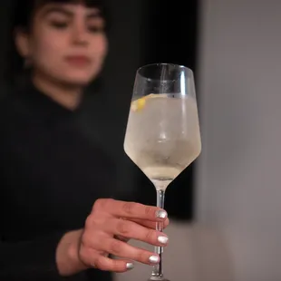 a woman holding a glass of wine