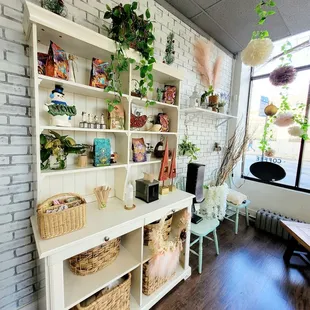 a white bookcase with baskets on top of it