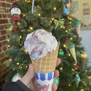 Raspberry chip ice cream in a fresh waffle cone.