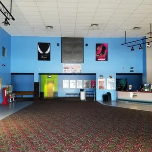 large central lobby with restrooms on the left, tickets/food on the right