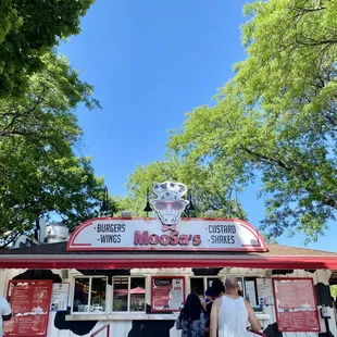 people standing in front of a food stand