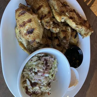 Wings with ginger and and aioli sauces and of course cranberry jalapeños slaw