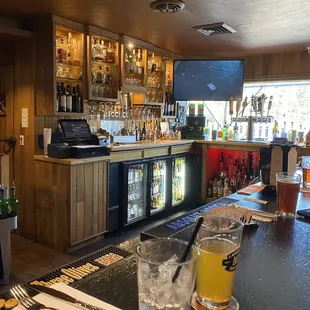 a bar with a television and drinks