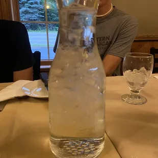 a man sitting at a table with a glass of water in front of him