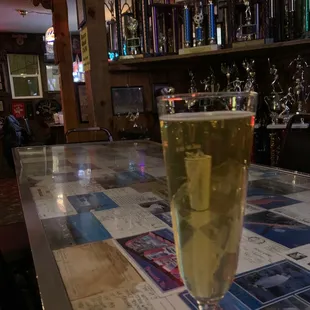 a glass of wine on a bar