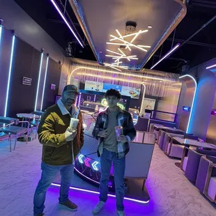 a man and a woman standing in a cafe