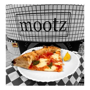 a slice of pizza on a paper plate