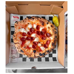 a pepperoni pizza in a box