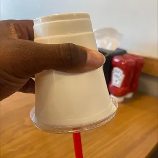 a hand holding a plastic cup