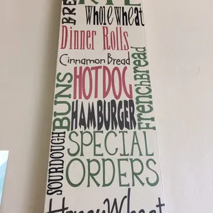 a wooden sign hanging on a wall