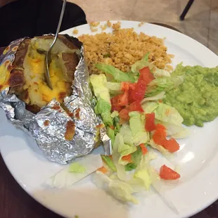 The side that comes with the ribeye plate.  Guacamole, baked potato, rice and salad.  Yummy!